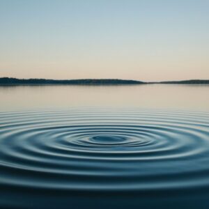A calm pond surrounded by nature with gentle ripples spreading across the water, symbolizing reflection, renewal, and the lasting impact one person can have through knowledge and service.